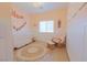 Cozy bedroom with soft pink tones, a crib, and a comfortable rocking chair at 1660 W Princeton Cir, Pahrump, NV 89060