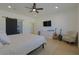 Bedroom with ceiling fan, TV, barn door to en suite bath, and seating area at 1660 W Princeton Cir, Pahrump, NV 89060