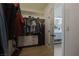 Walk-in closet with shelving, drawers and hanging rods with a door that leads to a bathroom at 1660 W Princeton Cir, Pahrump, NV 89060