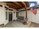 Close up of the front porch with a swing and American flag at 1660 W Princeton Cir, Pahrump, NV 89060