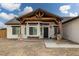 Inviting front porch with exposed beam detailing, swing, and stone accents at 1660 W Princeton Cir, Pahrump, NV 89060
