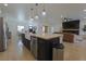 Open-concept kitchen with a large island flowing into the living area at 1660 W Princeton Cir, Pahrump, NV 89060