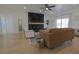 Bright living room with modern fireplace, wood mantle, plank accent wall, and sliding glass door at 1660 W Princeton Cir, Pahrump, NV 89060