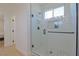 Modern glass shower with white subway tile, river rock floor, and black hardware at 1660 W Princeton Cir, Pahrump, NV 89060