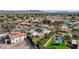 Aerial view of a neighborhood showcasing many single Gathering homes with pools and desert landscaping at 167 Ebb Tide Cir, Las Vegas, NV 89123