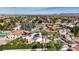Aerial view of neighborhood showcasing many homes, lush landscaping, and mountain views in background at 167 Ebb Tide Cir, Las Vegas, NV 89123