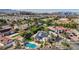 Aerial view shows large residence with a private pool, lush landscaping, and solar panels, located in a vibrant community at 167 Ebb Tide Cir, Las Vegas, NV 89123
