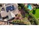 Aerial view of backyard with pool, mature trees and landscaping, and solar panels on the roof at 167 Ebb Tide Cir, Las Vegas, NV 89123