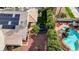Aerial view of backyard with pool, mature trees and landscaping, and solar panels on the roof at 167 Ebb Tide Cir, Las Vegas, NV 89123