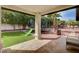 Spacious backyard with mature trees and a trampoline under a covered patio at 167 Ebb Tide Cir, Las Vegas, NV 89123