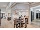 Cozy bar area with wine fridge and seating, next to an open concept floor plan with lots of natural light at 167 Ebb Tide Cir, Las Vegas, NV 89123