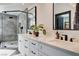 Bathroom featuring double sinks, black hardware and walk in shower at 167 Ebb Tide Cir, Las Vegas, NV 89123