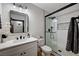 Modern bathroom with a stand-up shower, a decorative mirror, and marble countertops at 167 Ebb Tide Cir, Las Vegas, NV 89123
