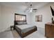 Bedroom with a gray bed, window and dresser with artwork at 167 Ebb Tide Cir, Las Vegas, NV 89123