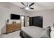 Bedroom featuring a ceiling fan, dark closet doors and a TV at 167 Ebb Tide Cir, Las Vegas, NV 89123