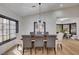 Elegant dining room with modern lighting and a view into another dining space and kitchen at 167 Ebb Tide Cir, Las Vegas, NV 89123