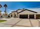 Attractive home with dark trim, a circular driveway, plush turf, and three-car garage at 167 Ebb Tide Cir, Las Vegas, NV 89123