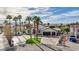 Stunning home featuring dark trim, a circular driveway, lush turf, and a three-car garage at 167 Ebb Tide Cir, Las Vegas, NV 89123
