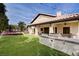 Rear exterior of the house featuring a spacious backyard, grill, and a trampoline at 167 Ebb Tide Cir, Las Vegas, NV 89123