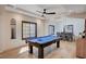 Game room with pool table, wood floors, natural light coming in from the large windows, and a ceiling fan at 167 Ebb Tide Cir, Las Vegas, NV 89123