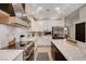 Modern kitchen with stainless steel appliances, white cabinets, and an island with marble countertops at 167 Ebb Tide Cir, Las Vegas, NV 89123