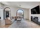 Spacious living room with high ceilings, modern fireplace, arch windows, sleek floors and comfortable seating at 167 Ebb Tide Cir, Las Vegas, NV 89123