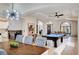 Open-concept living room features a pool table and large windows providing lots of natural light at 167 Ebb Tide Cir, Las Vegas, NV 89123