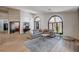 Bright living room featuring large windows, modern decor, and wood-look floors at 167 Ebb Tide Cir, Las Vegas, NV 89123