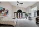 A large main bedroom featuring a modern ceiling fan, fireplace, and doors leading to the backyard at 167 Ebb Tide Cir, Las Vegas, NV 89123
