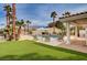 Lounge by the pool in this backyard oasis with well manicured turf and desert landscape at 167 Ebb Tide Cir, Las Vegas, NV 89123
