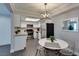 Charming dining area adjacent to kitchen, illuminated by stylish modern lighting fixture at 1701 E Katie Ave # 51, Las Vegas, NV 89119