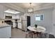Bright dining area featuring modern lighting and seating near the kitchen and stainless steel appliances at 1701 E Katie Ave # 51, Las Vegas, NV 89119