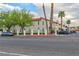 View of white buildings with red tile roofs, green trees and parked cars at 1701 E Katie Ave # 51, Las Vegas, NV 89119
