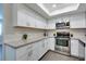 Modern kitchen featuring stainless steel appliances, granite countertops, and white cabinets at 1701 E Katie Ave # 51, Las Vegas, NV 89119