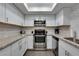 Well-lit kitchen featuring stainless steel appliances, bright skylight, and stylish backsplash at 1701 E Katie Ave # 51, Las Vegas, NV 89119