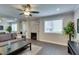Cozy living room with fireplace, a modern ceiling fan, and plenty of natural light at 1701 E Katie Ave # 51, Las Vegas, NV 89119