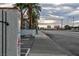 Street view with palm trees lining the street, leading to buildings in the distance on a cloudy day at 1701 E Katie Ave # 51, Las Vegas, NV 89119