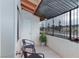 Charming balcony with tiled flooring, black metal railing, and seating for two at 1701 E Katie Ave # 68, Las Vegas, NV 89119