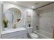 Charming bathroom with modern vanity, round mirror, and stylish marble-look shower and tub combination at 1701 E Katie Ave # 68, Las Vegas, NV 89119