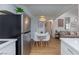 A stainless steel fridge, dining table, and living room highlight this space at 1701 E Katie Ave # 68, Las Vegas, NV 89119
