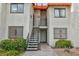 Exterior view of building with stairs leading up to condos and well kept plants at 1701 E Katie Ave # 68, Las Vegas, NV 89119
