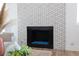 Close-up of modern fireplace with decorative tile surround and glass stones at 1701 E Katie Ave # 68, Las Vegas, NV 89119