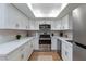 Updated kitchen features white cabinets, stainless steel appliances, and bright countertops at 1701 E Katie Ave # 68, Las Vegas, NV 89119
