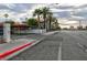 Street view of the condo with palm trees, carport, and a view of city buildings in the distance at 1701 E Katie Ave # 68, Las Vegas, NV 89119