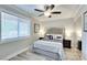 Bright bedroom with a ceiling fan, light wood floors, and ample natural light at 1701 E Katie Ave # 9, Las Vegas, NV 89119