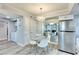Dining area with a round glass table, mirrored wall, and access to the kitchen and laundry room at 1701 E Katie Ave # 9, Las Vegas, NV 89119