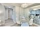 Bright dining area with a round glass table and white chairs, featuring a mirrored wall and open access to the laundry room at 1701 E Katie Ave # 9, Las Vegas, NV 89119
