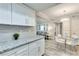 Bright kitchen features granite counters, white cabinets, stainless steel hardware and open floor plan at 1701 E Katie Ave # 9, Las Vegas, NV 89119