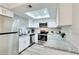 Well-lit kitchen features stainless steel appliances, granite countertops, skylight and white cabinetry at 1701 E Katie Ave # 9, Las Vegas, NV 89119