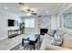 Bright living room with a stone fireplace, ceiling fan, and comfortable seating, perfect for relaxing and entertaining at 1701 E Katie Ave # 9, Las Vegas, NV 89119